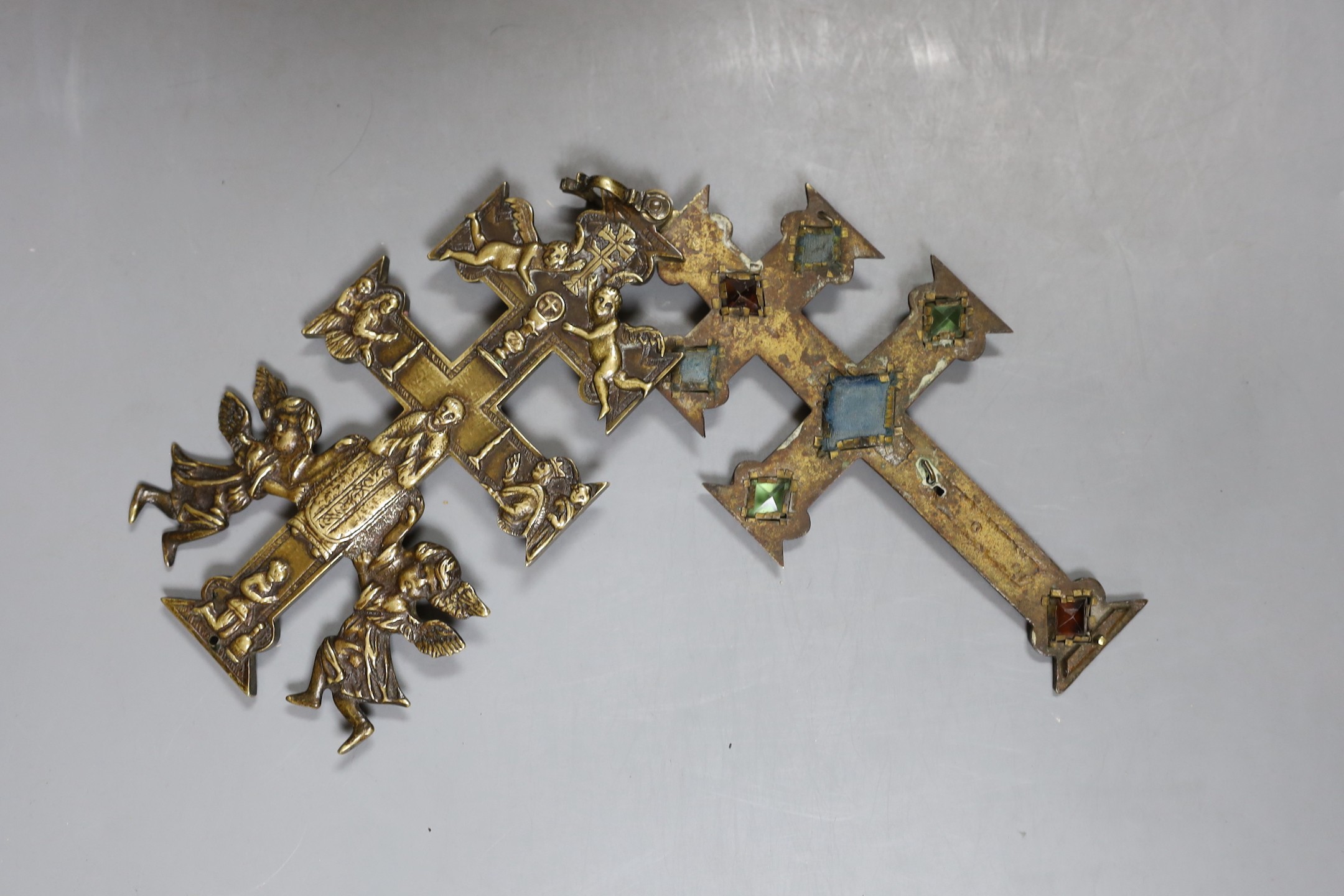 A brass stained glass crucifix inscribed ‘INRI’ with swivel movement - 18cm high